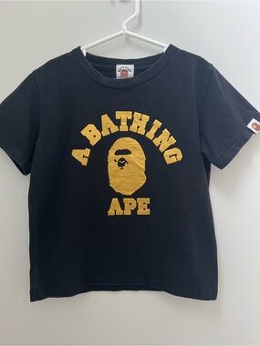 Bape Kids Black Tee with Gold Logo Print a bathing ape